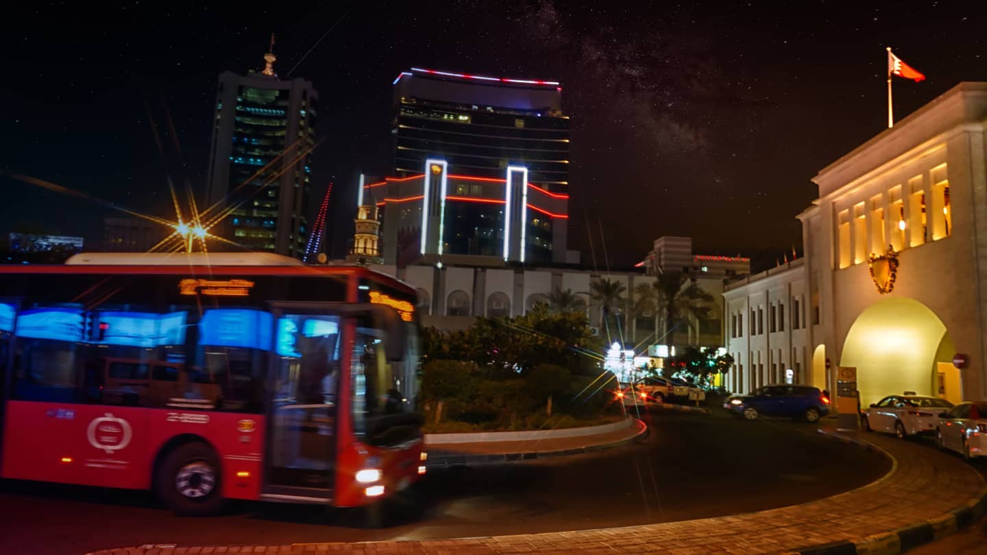 City night scene with moving bus
